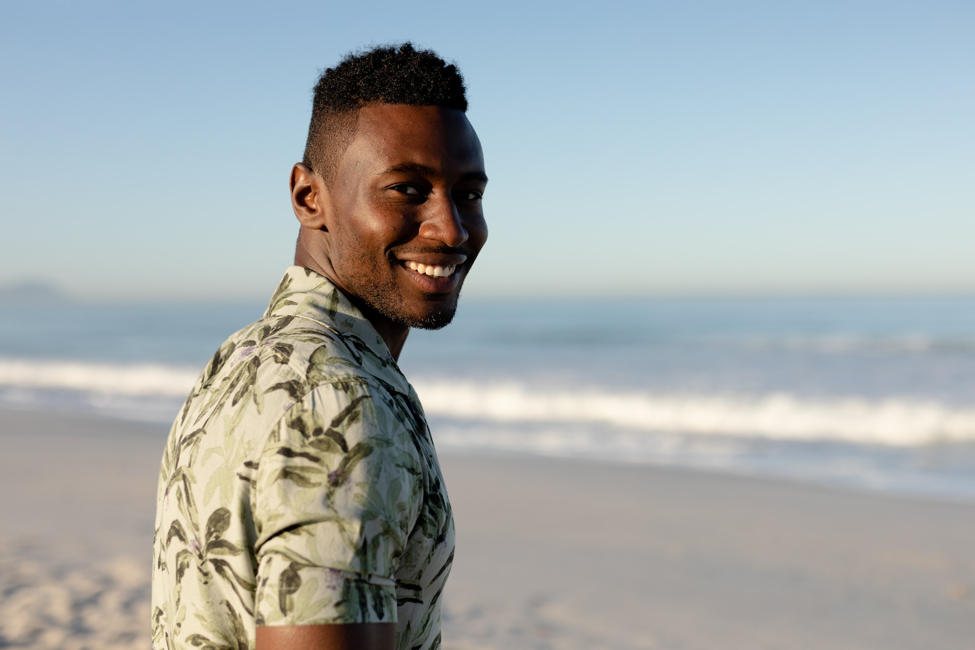 An African American man enjoying free time on beach on a sunny day